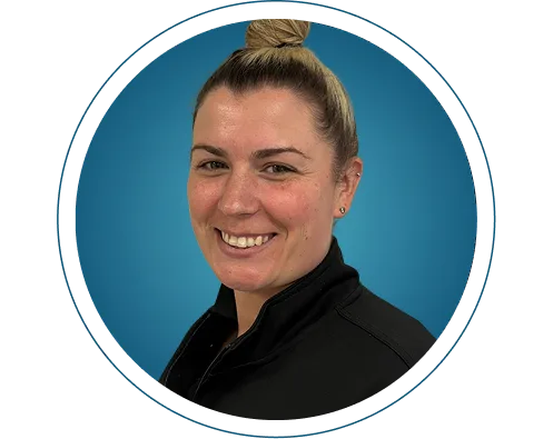 Staff member Liz smiling at camera, wearing black polo shirt