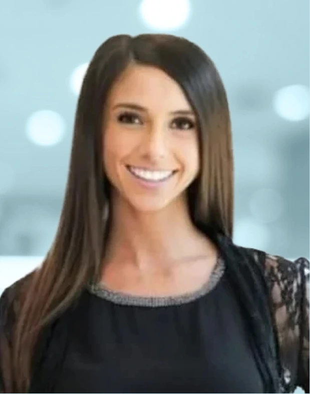 Professional headshot of smiling woman with long dark hair wearing black lace top