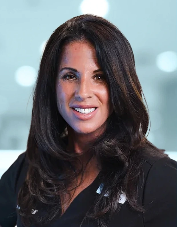 Professional headshot of woman with long dark hair smiling, wearing black shirt