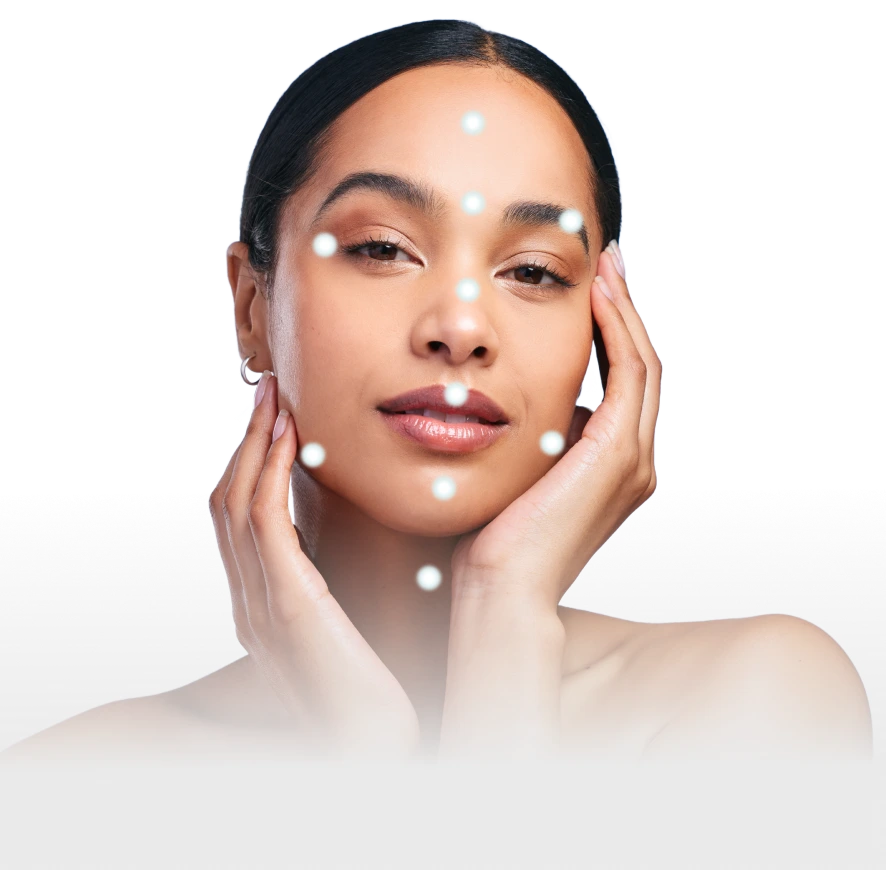 Woman's face with white dots marking facial zones for Botox treatment application