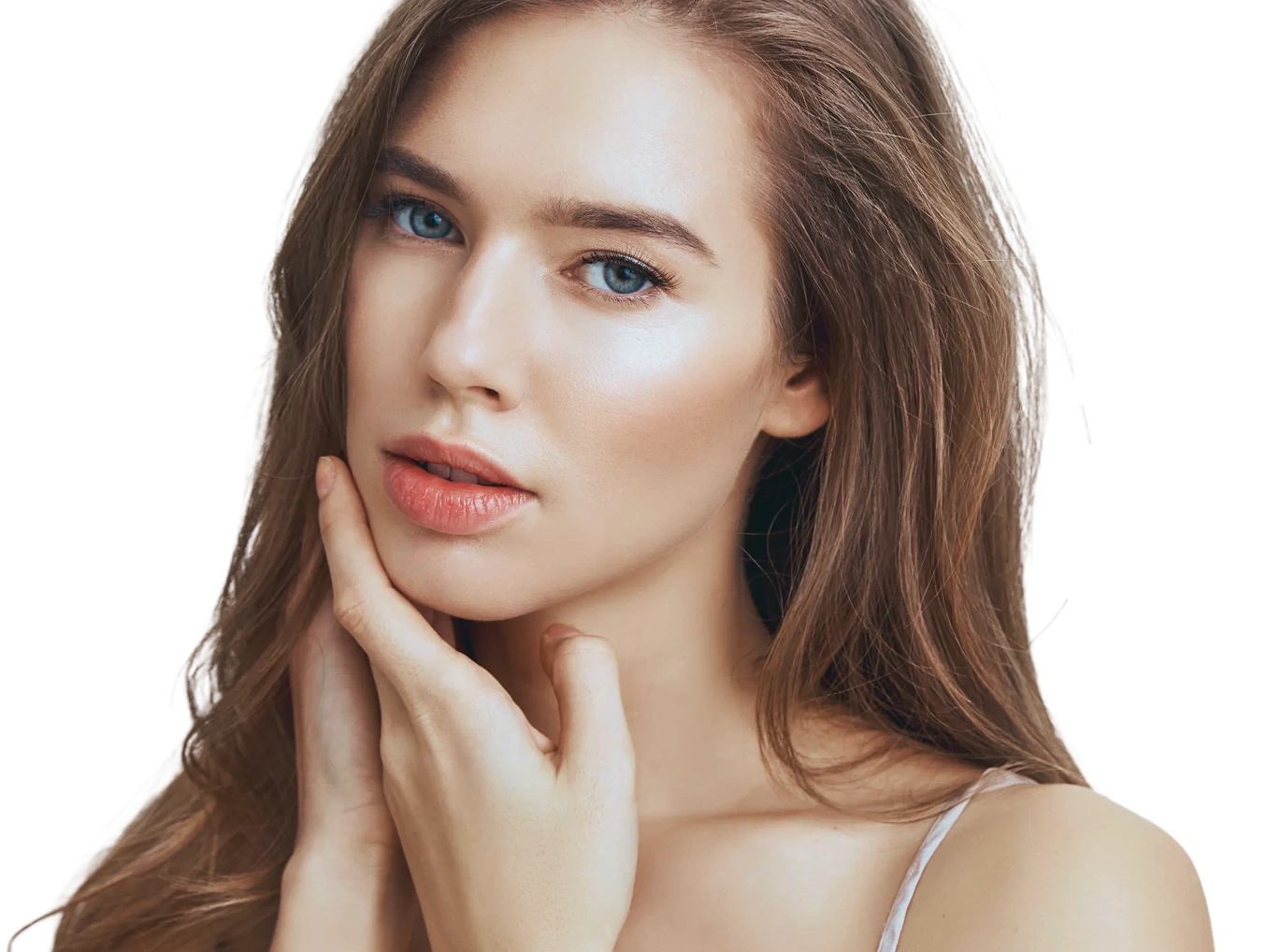 Woman with long brown hair touching her cheek, displaying smooth skin and natural makeup