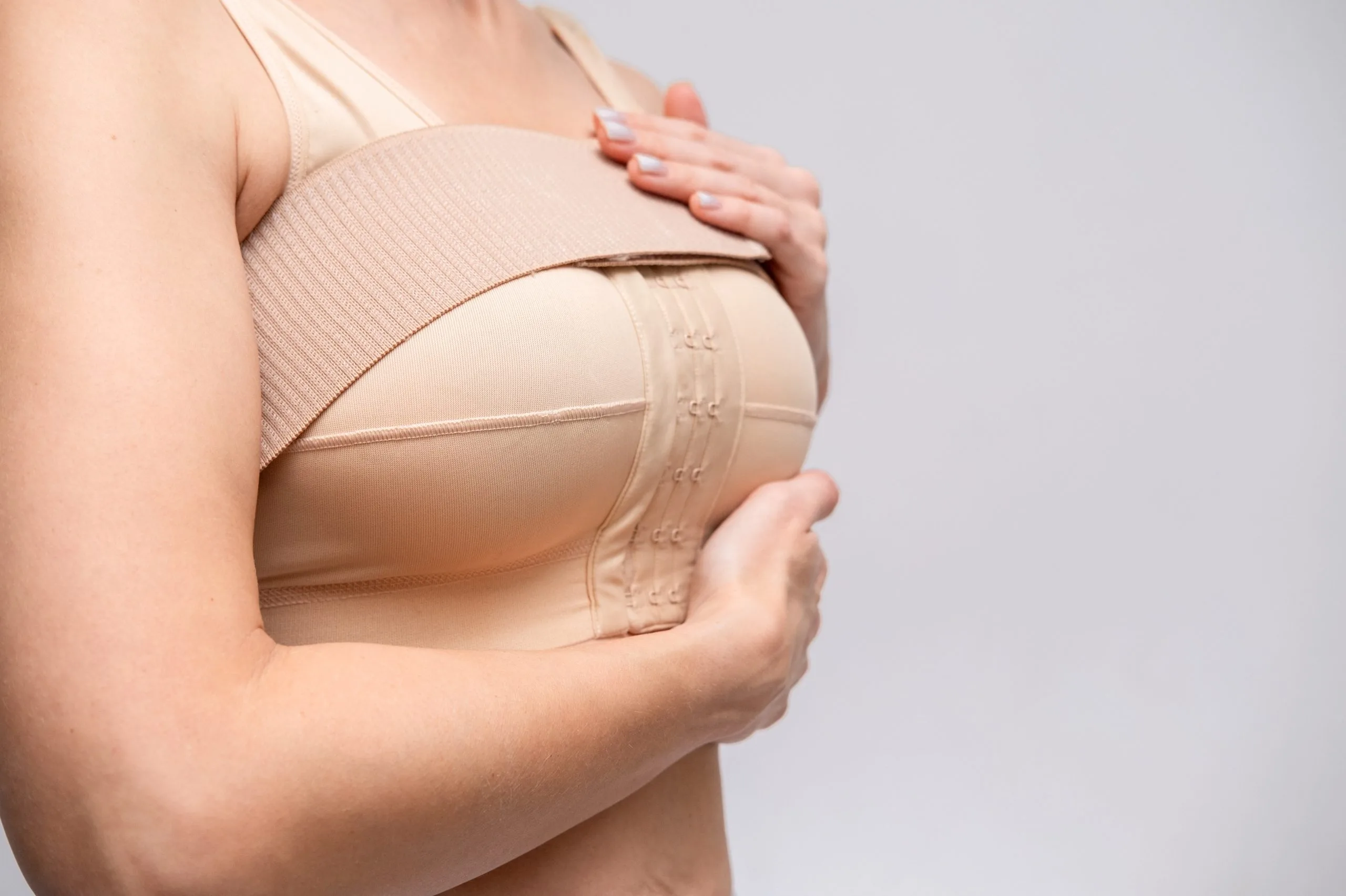 Woman wearing compression garment after body contouring surgery