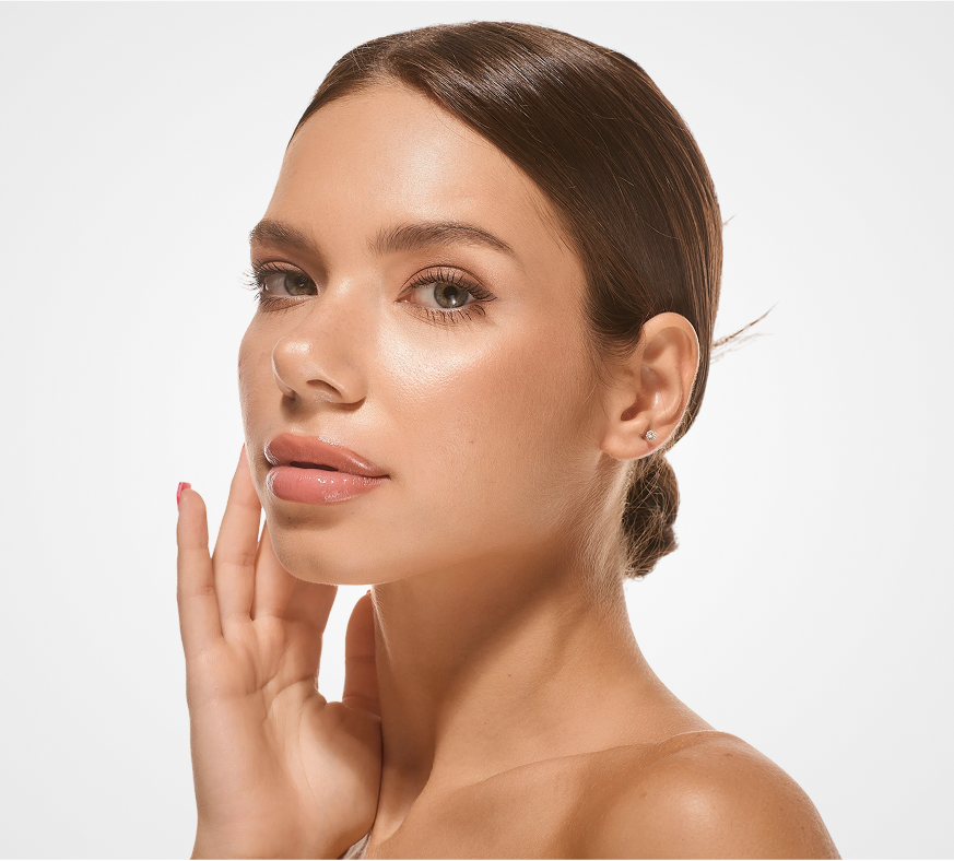 Woman in profile with hand near face, showing clear complexion and defined facial features