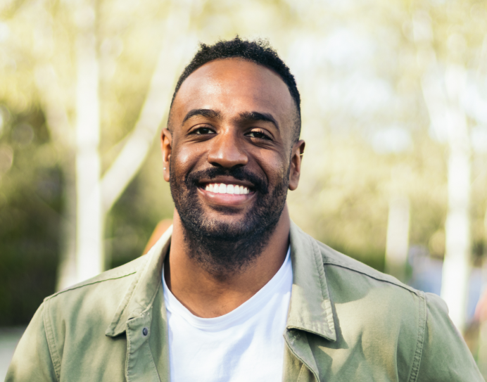 Smiling man outdoors in casual sage green shirt