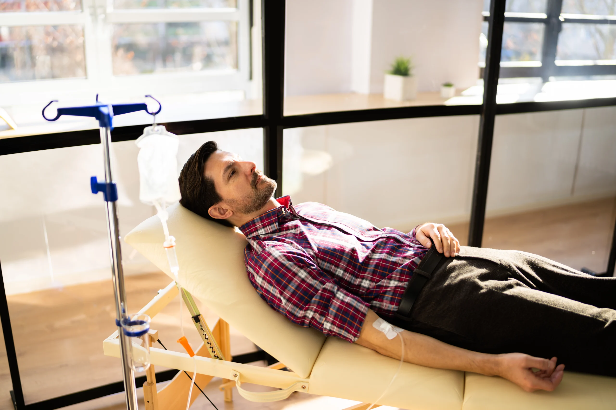 Man resting in a reclining chair during an IV infusion