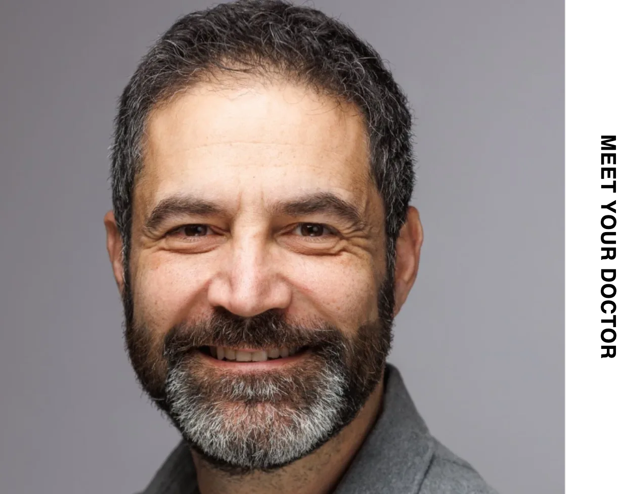 Lindsay Kiriakos MD, a male physician with dark hair and beard, smiling at camera in professional headshot