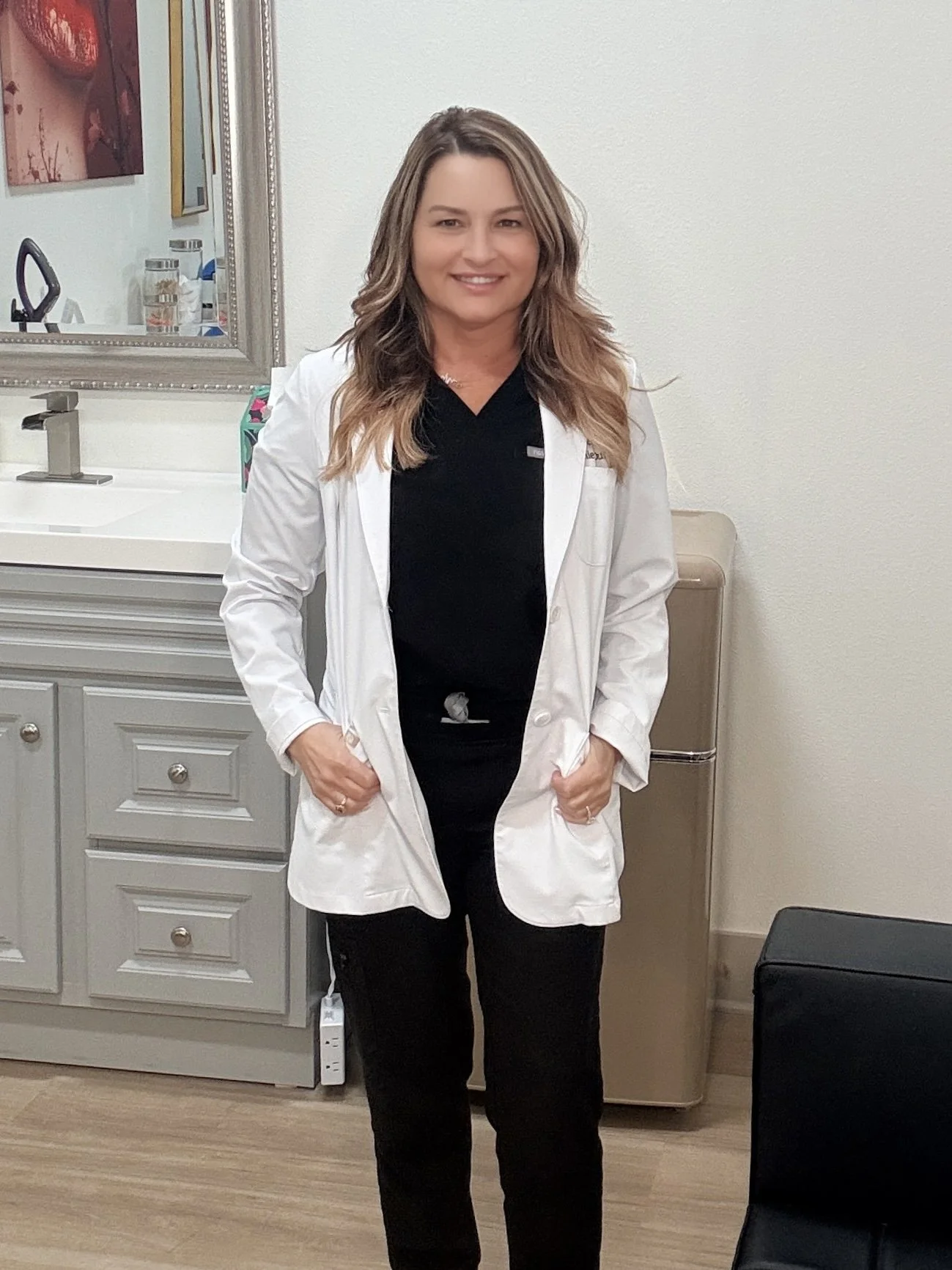 Stephanie Duffy in white lab coat standing in AZ Medspa 48 treatment room