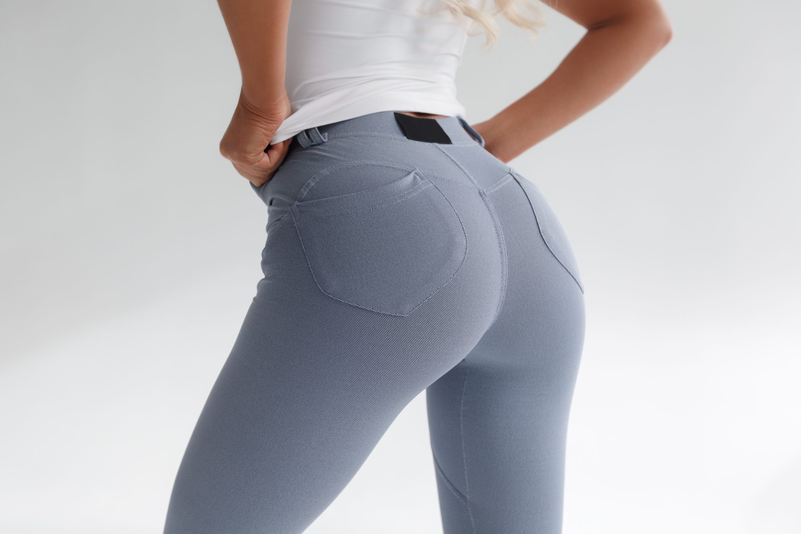 Model in fitted leggings showcasing enhanced buttocks profile