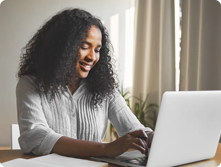 Woman smiling during an online appointment on her laptop