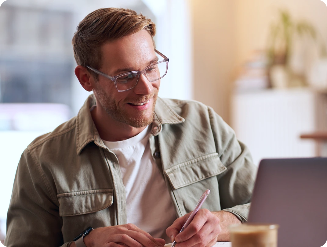 Man smiling during a video visit on his laptop