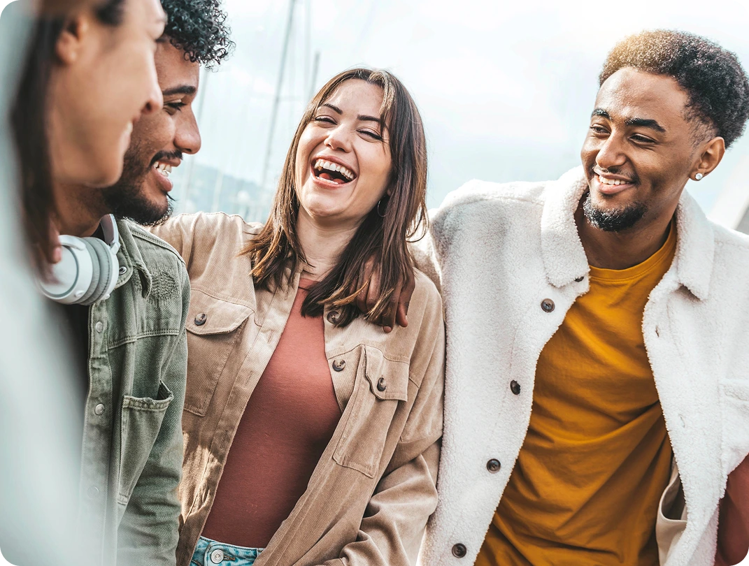 Group of friends laughing together outdoors