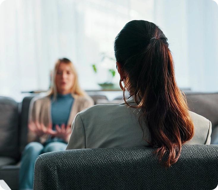 Patient and clinician in consultation discussing pain conditions in bright office setting