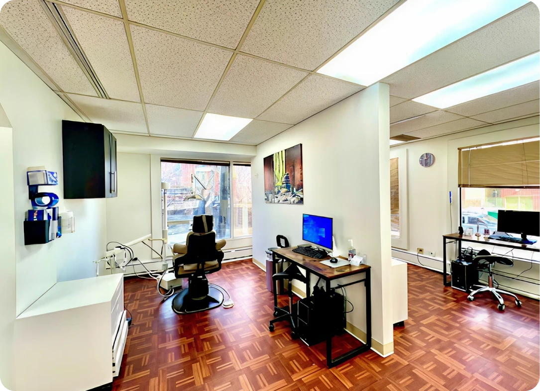 Brilliant Family Dentistry's modern dental operatory with treatment chair, computer workstation, and city views from large windows