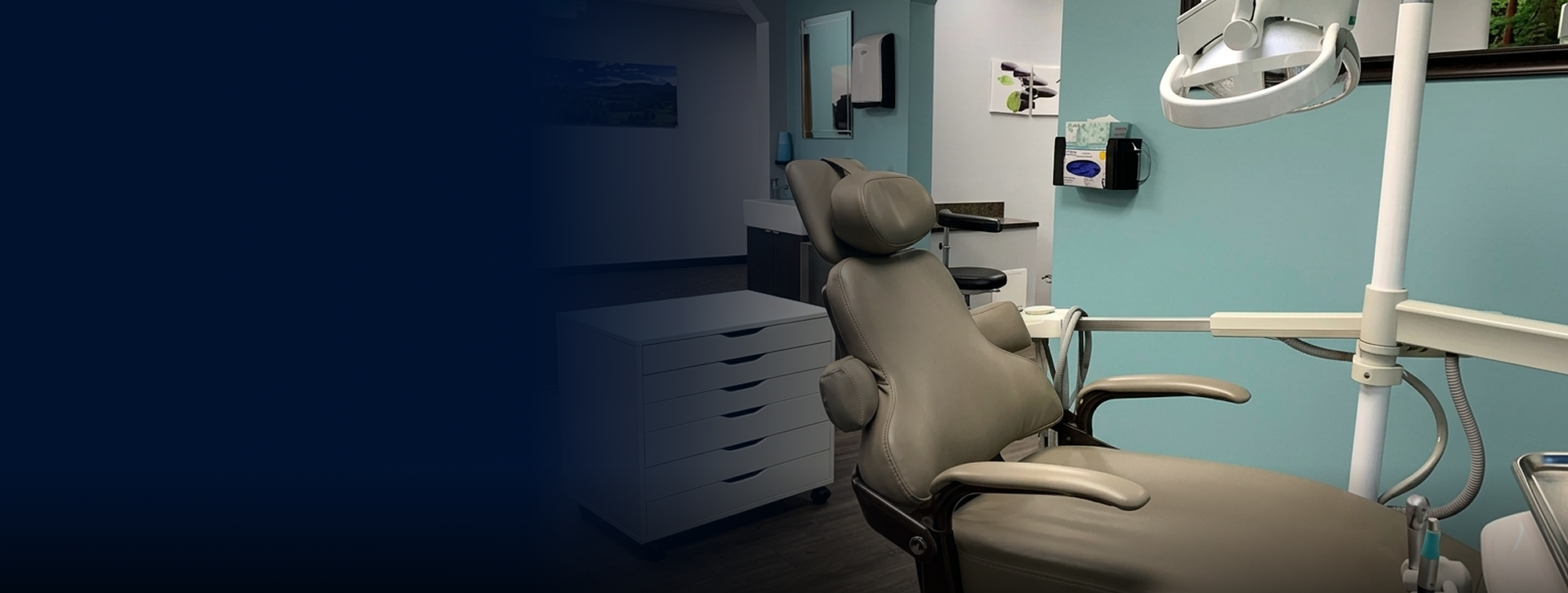 Modern dental operatory with patient chair, computer workstation, and overhead lighting