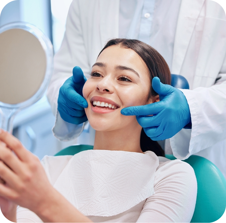 Dentist in gloves examining smiling patient's teeth with mirror