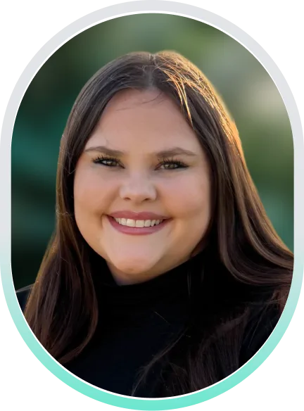 Dr. Kaitlyn Richard, Psy.D., smiling portrait with blurred green background