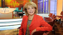 Woman in red jacket on television talk show set