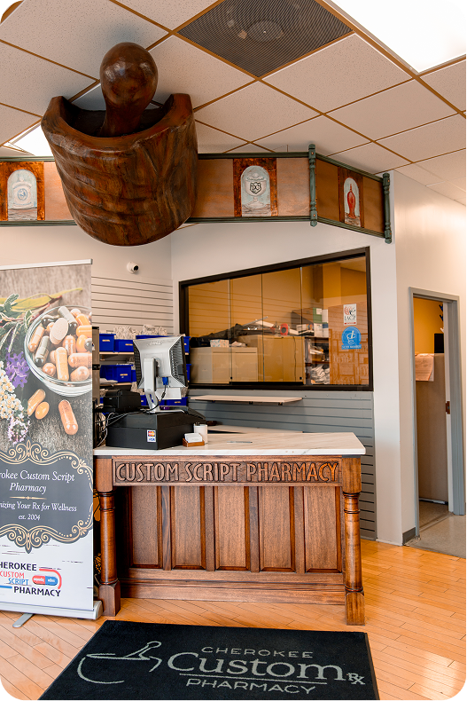 Cherokee Custom Script Pharmacy interior with wooden counter, signage, and decorative mortar sculpture