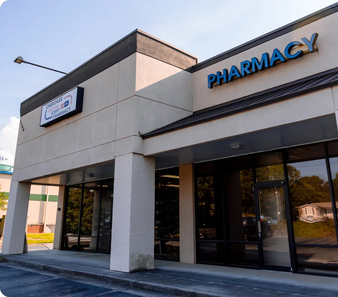 Cherokee Custom Script Pharmacy building facade with large blue pharmacy lettering and entrance