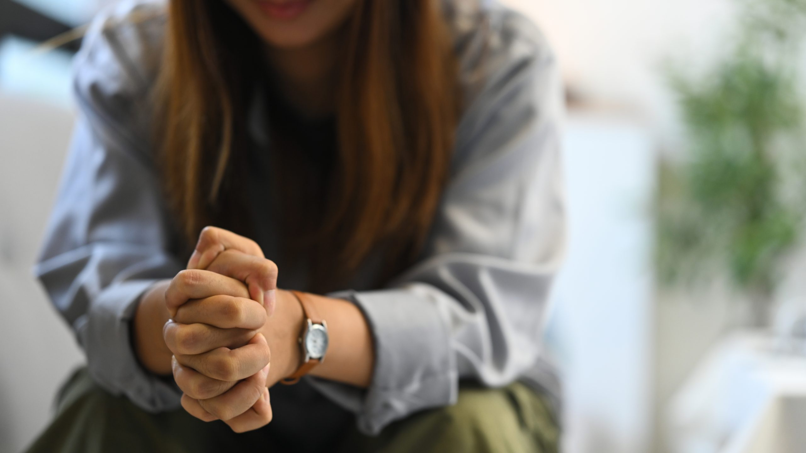 Woman displaying custom medication on wrist with home setting in background