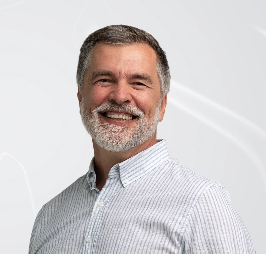 Smiling man with dental implants demonstrating successful all-on-4 treatment result