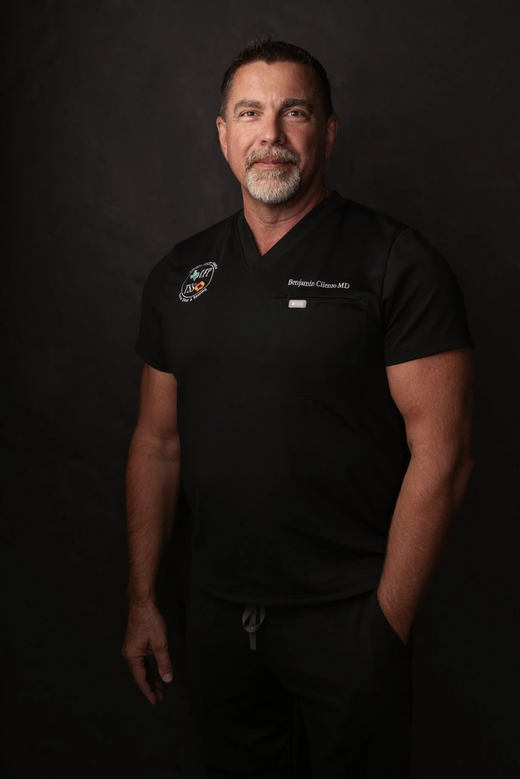 Benjamin Cicero MD in black medical scrubs with clinic logo