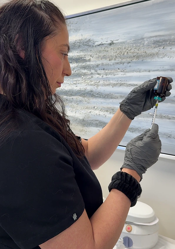 Med spa provider preparing B12 injection in syringe during wellness treatment