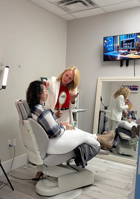 Injector consulting with seated patient in treatment room before injectable procedure