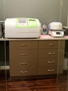 PlanMill 4D milling machine and supporting dental lab equipment on a clinical counter