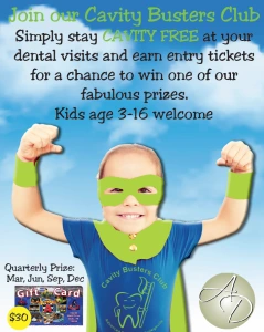 Child in green superhero mask and cape with fists raised, promoting Cavity Busters Club program for kids ages 3-16 with quarterly prize details