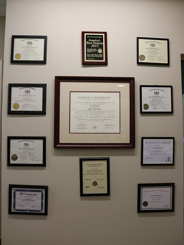 Wall of Dr. Silva’s diplomas and credentials in the office