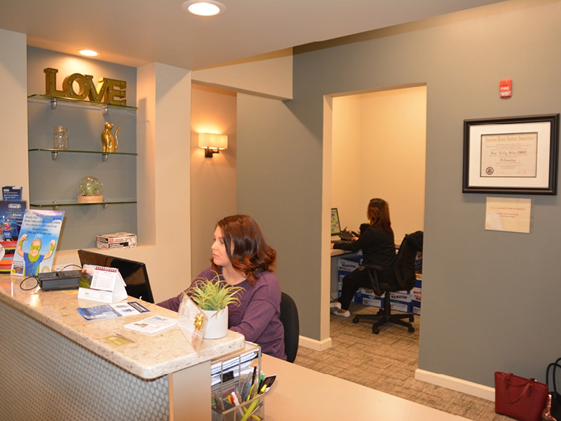 Friendly front desk team welcoming patients in Collegeville