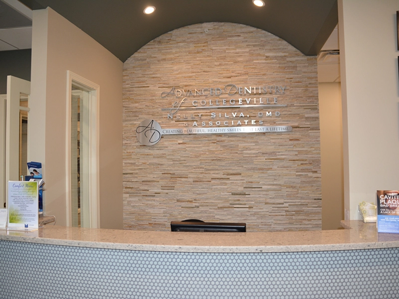 Reception desk and waiting area at the Collegeville dental office