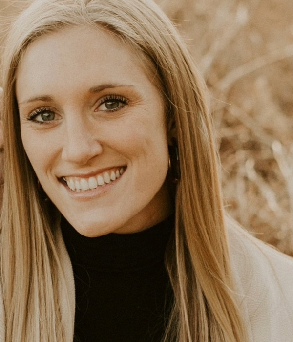 Alexandra O'Malley smiling at camera with long blonde hair