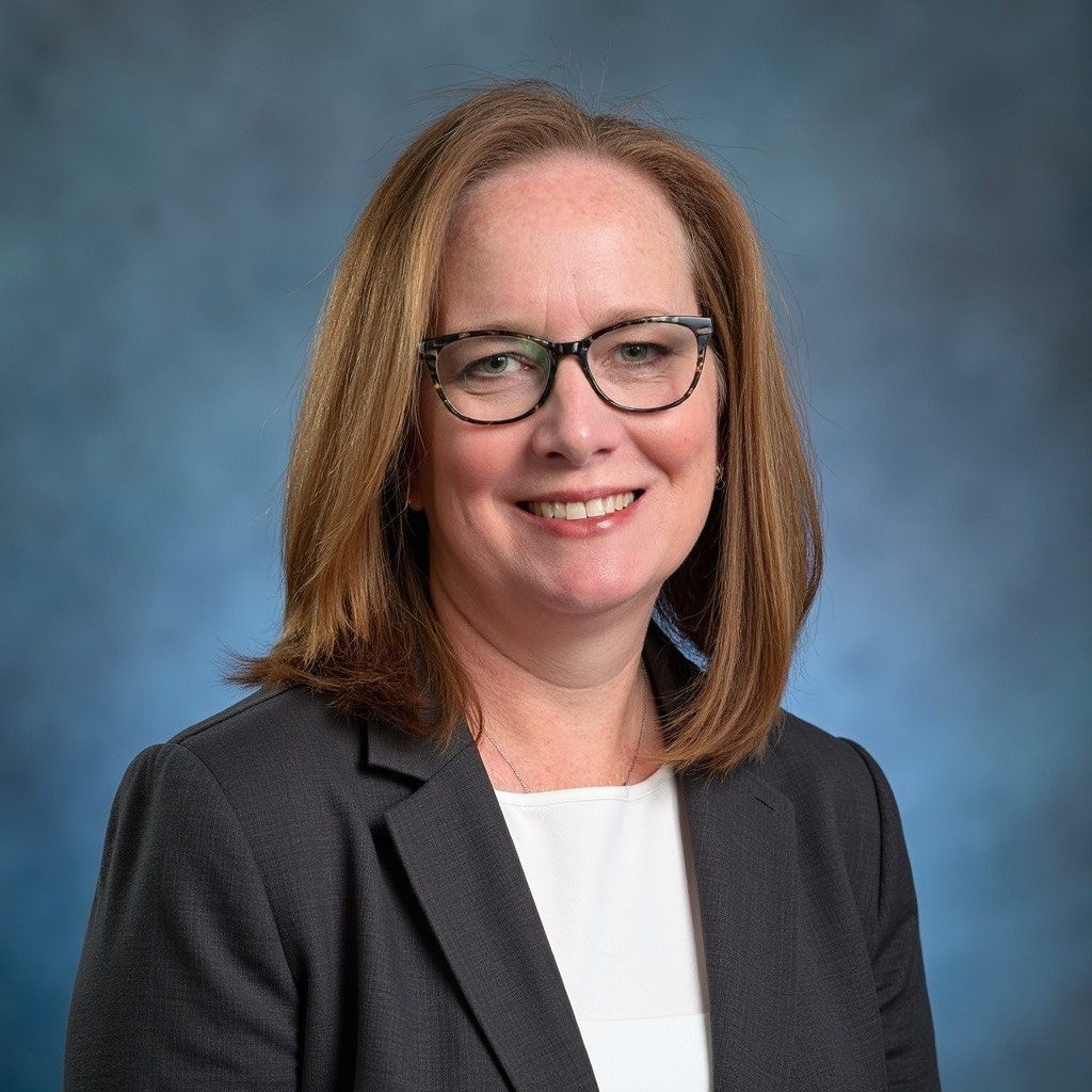 Allyson Florkowski professional headshot wearing glasses and dark blazer