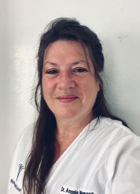 Dr. Angela Marques in white clinical coat