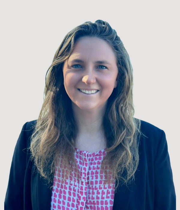 Christina, team member at Contemporary Care, wearing navy blazer and patterned pink top