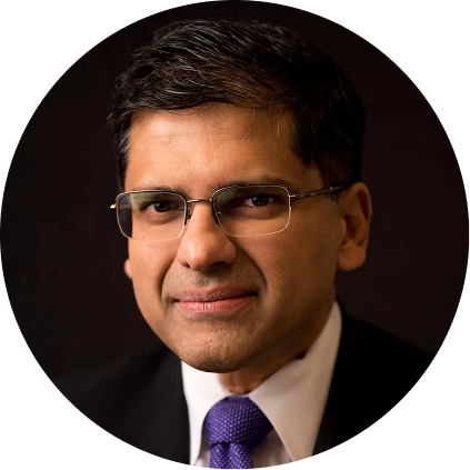 Man wearing glasses and purple tie, professional headshot
