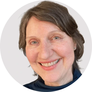 Woman with short brown hair smiling at camera