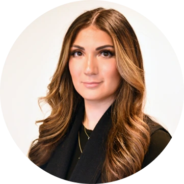 Professional headshot of woman with long brown hair wearing black top