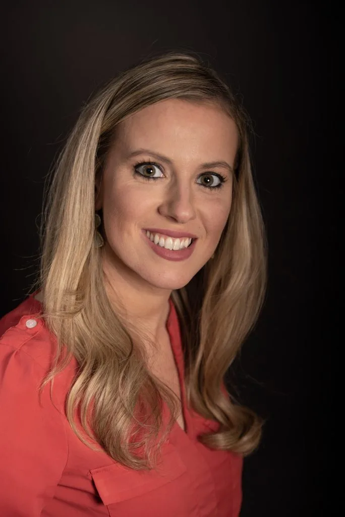 Erin McCann, team member at Contemporary Care, smiling in professional headshot wearing red top