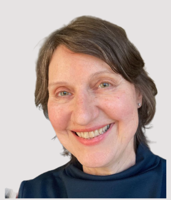 Irena Michals, smiling at camera, wearing dark blue top