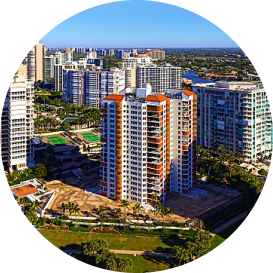 Aerial view of colorful residential high-rise buildings near water and green landscape