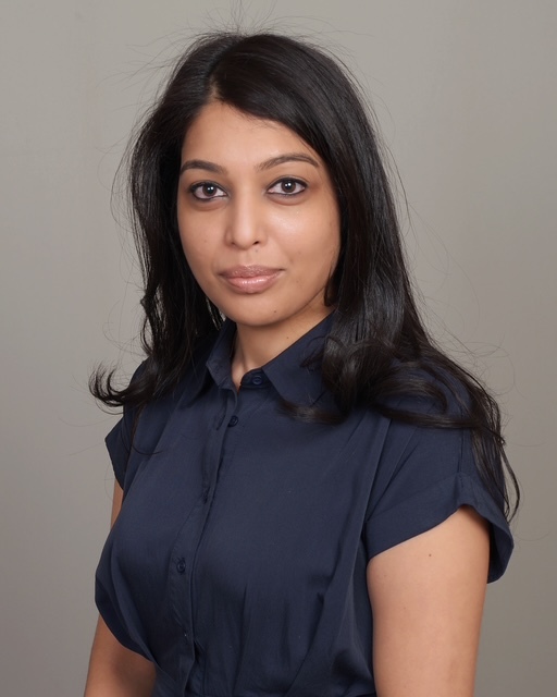 Woman with long black hair wearing dark blue shirt