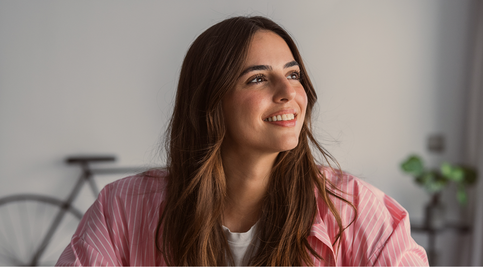 Smiling woman in pink shirt in bright office setting
