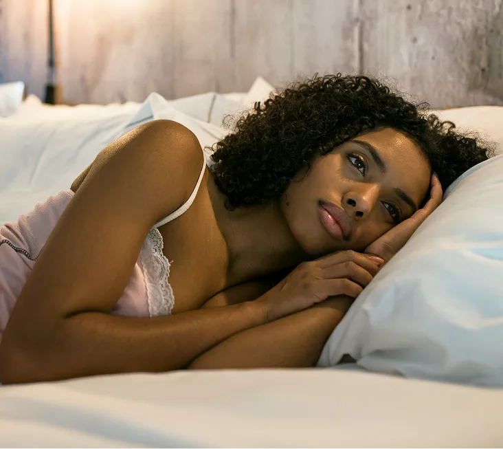Woman resting in bed trying to sleep