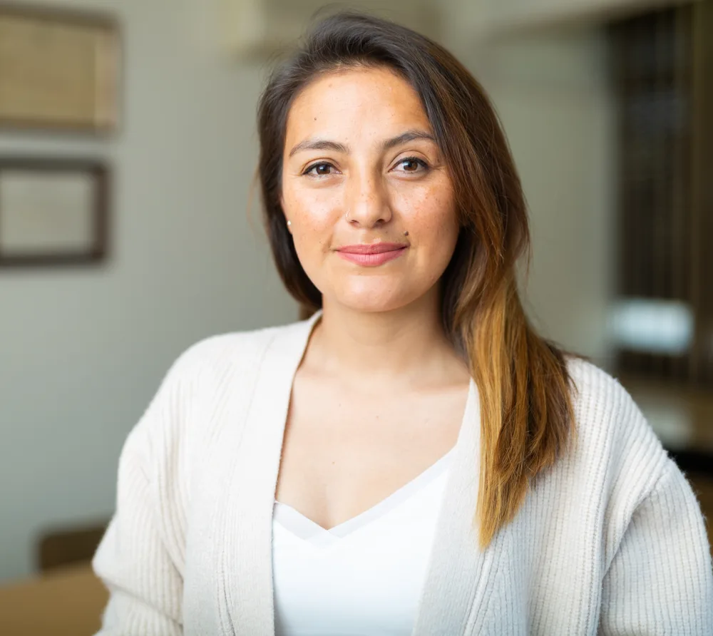 Smiling woman in a cream cardigan
