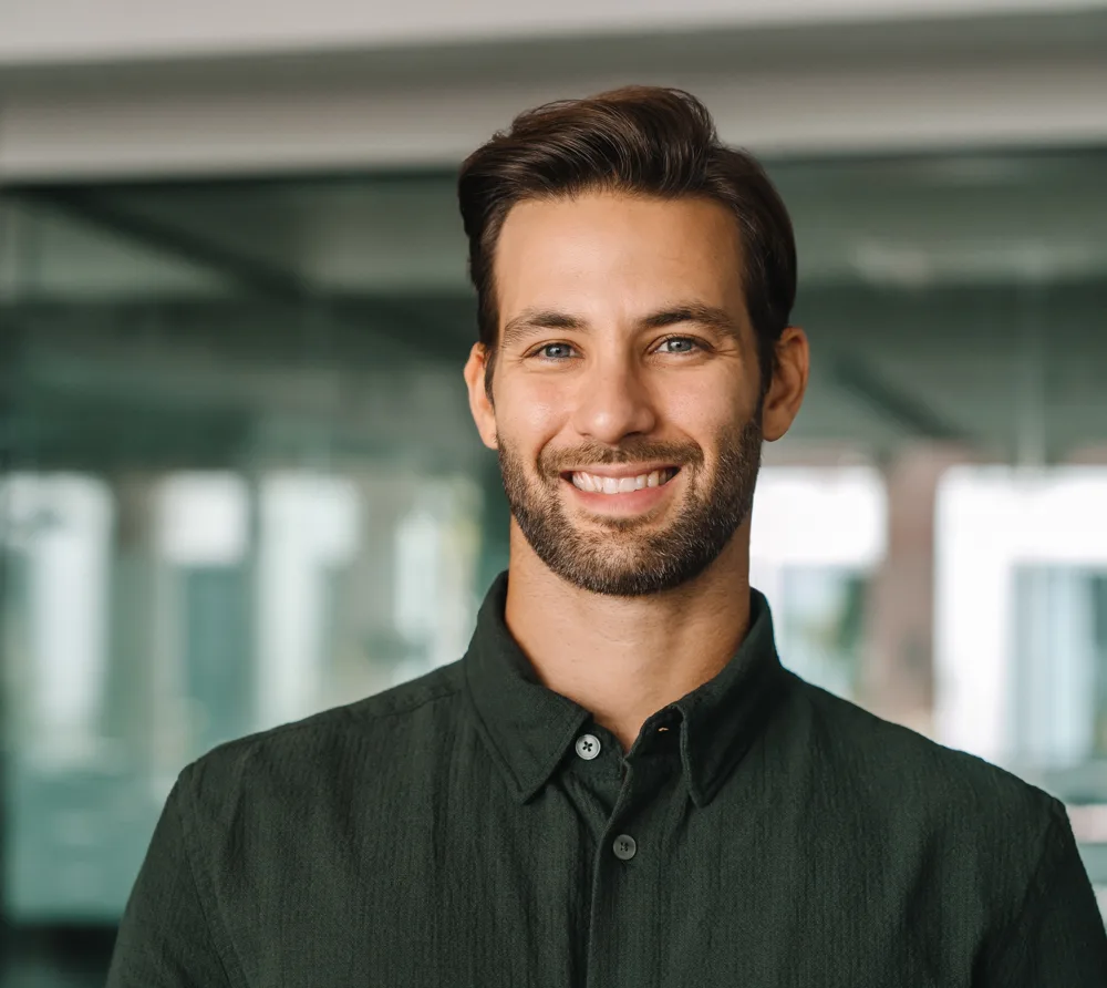 Smiling bearded man in a dark shirt