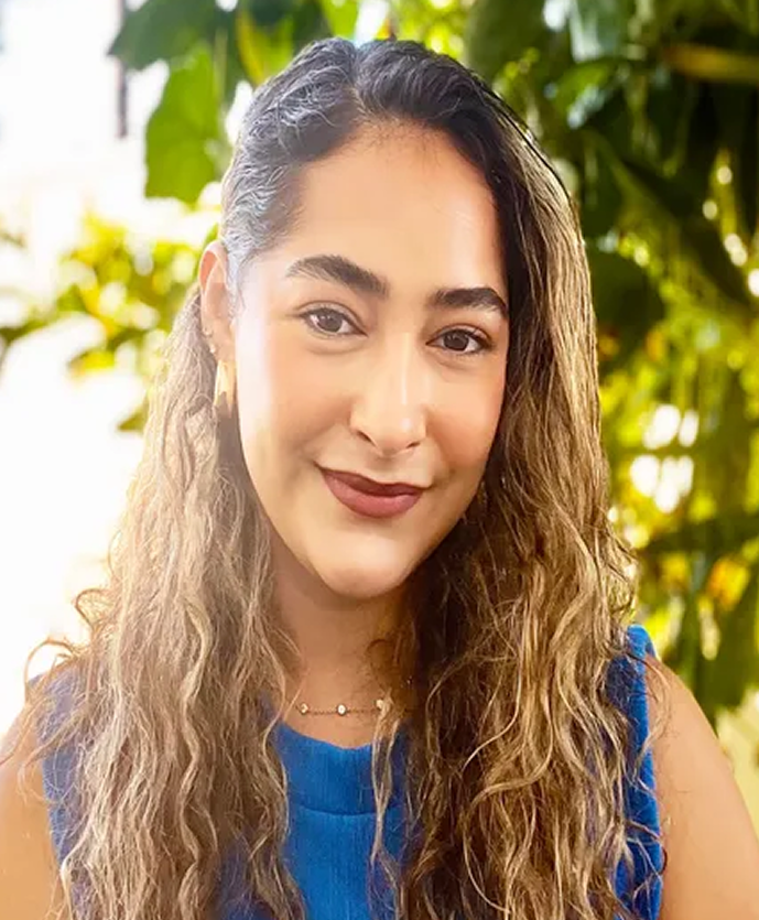 Giselle, a counselor at Daybreak Counseling Center, smiling outdoors in a blue top