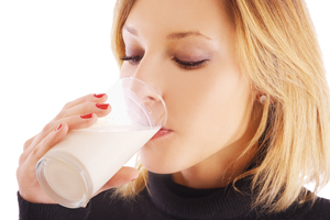 Woman drinking a glass of milk